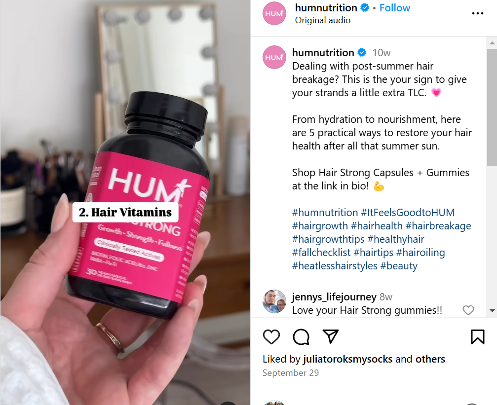 Hum video ad showing Hair Strong supplements held by a hand. The bottle has a bright pink label.